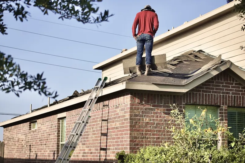 Professional roofer working on a residential roof in Traditions